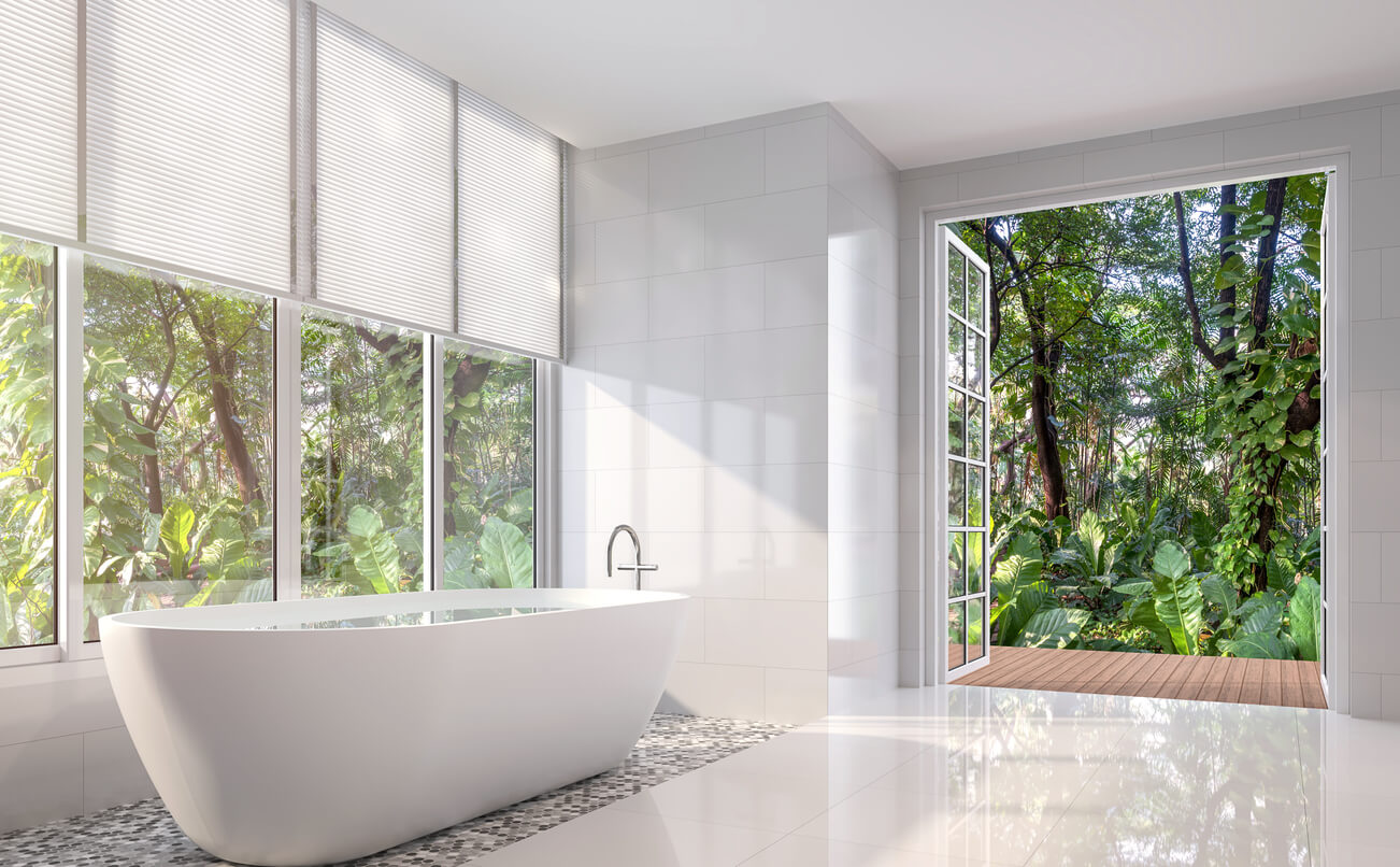 Modern white bath room 3d render. There are white tile wall and floor.The room has large open door looking out to the tropical garden.